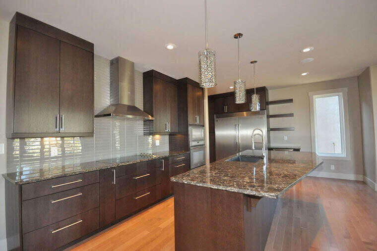 Dark cabinetry kitchen with granite island