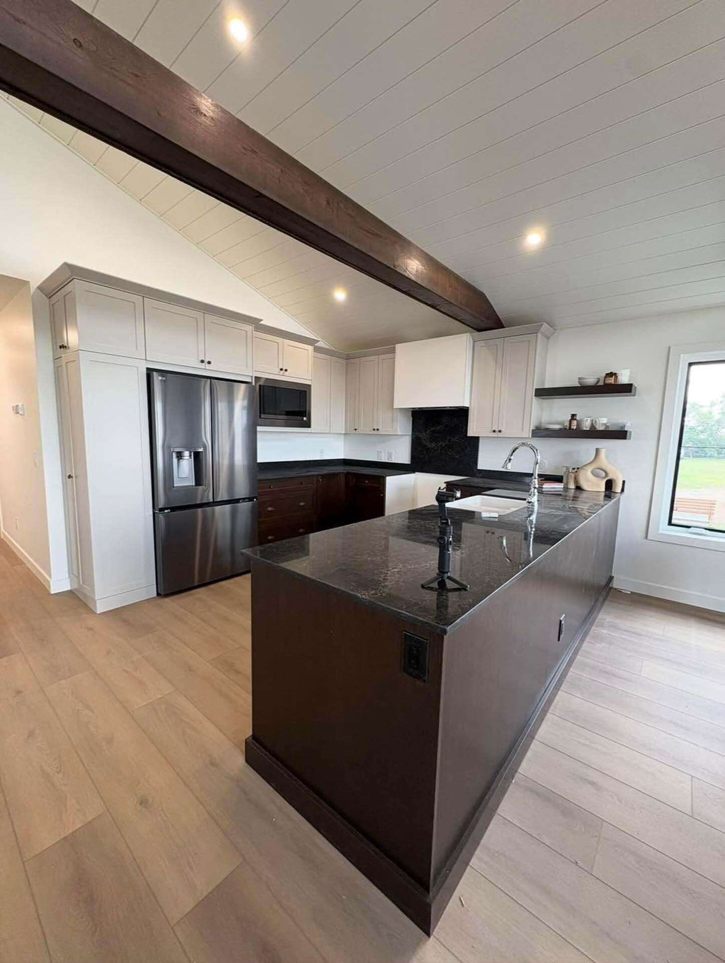 Kitchen with dark stone countertops and pendant lighting
