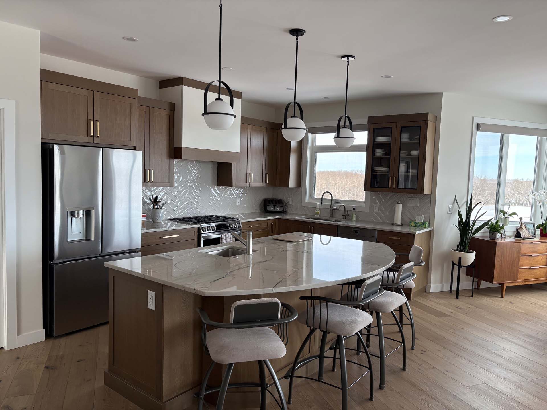 Kitchen with veined stone countertops and warm wood cabinets