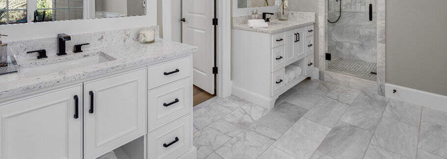 Custom bathroom vanities with stone tops and precise cabinetry