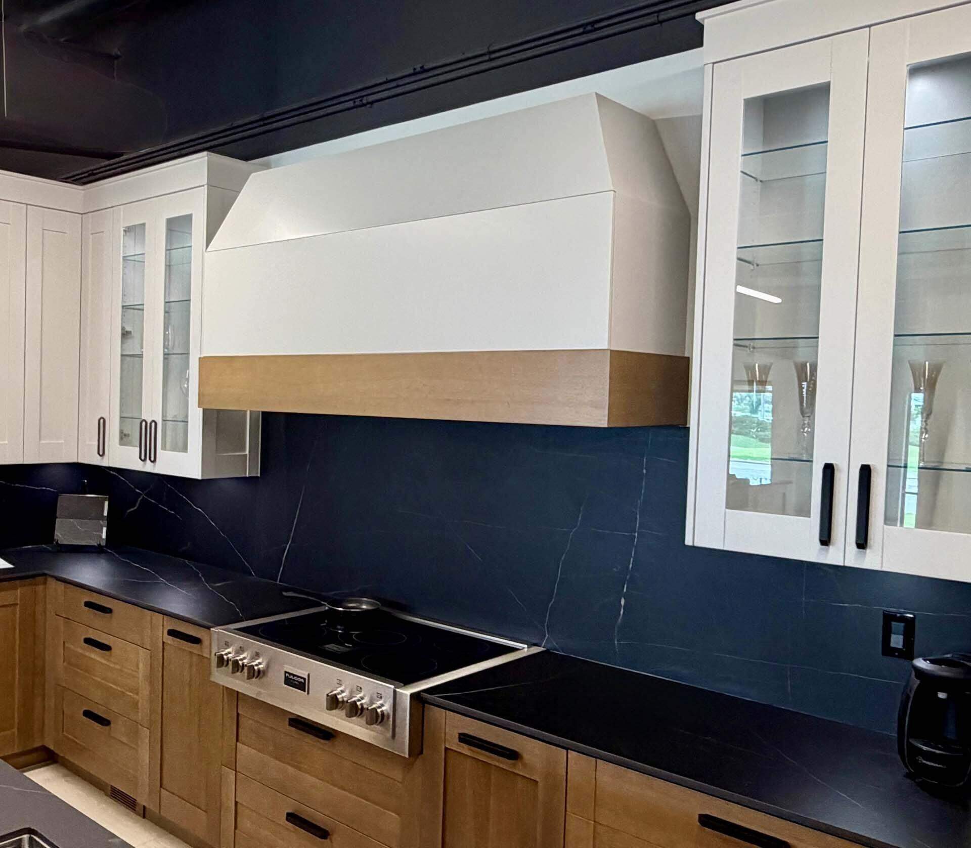 Custom wood range hood over navy backsplash