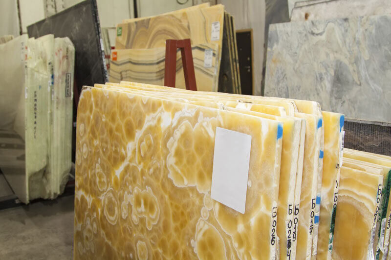 Stacked onyx slabs in warm amber tones