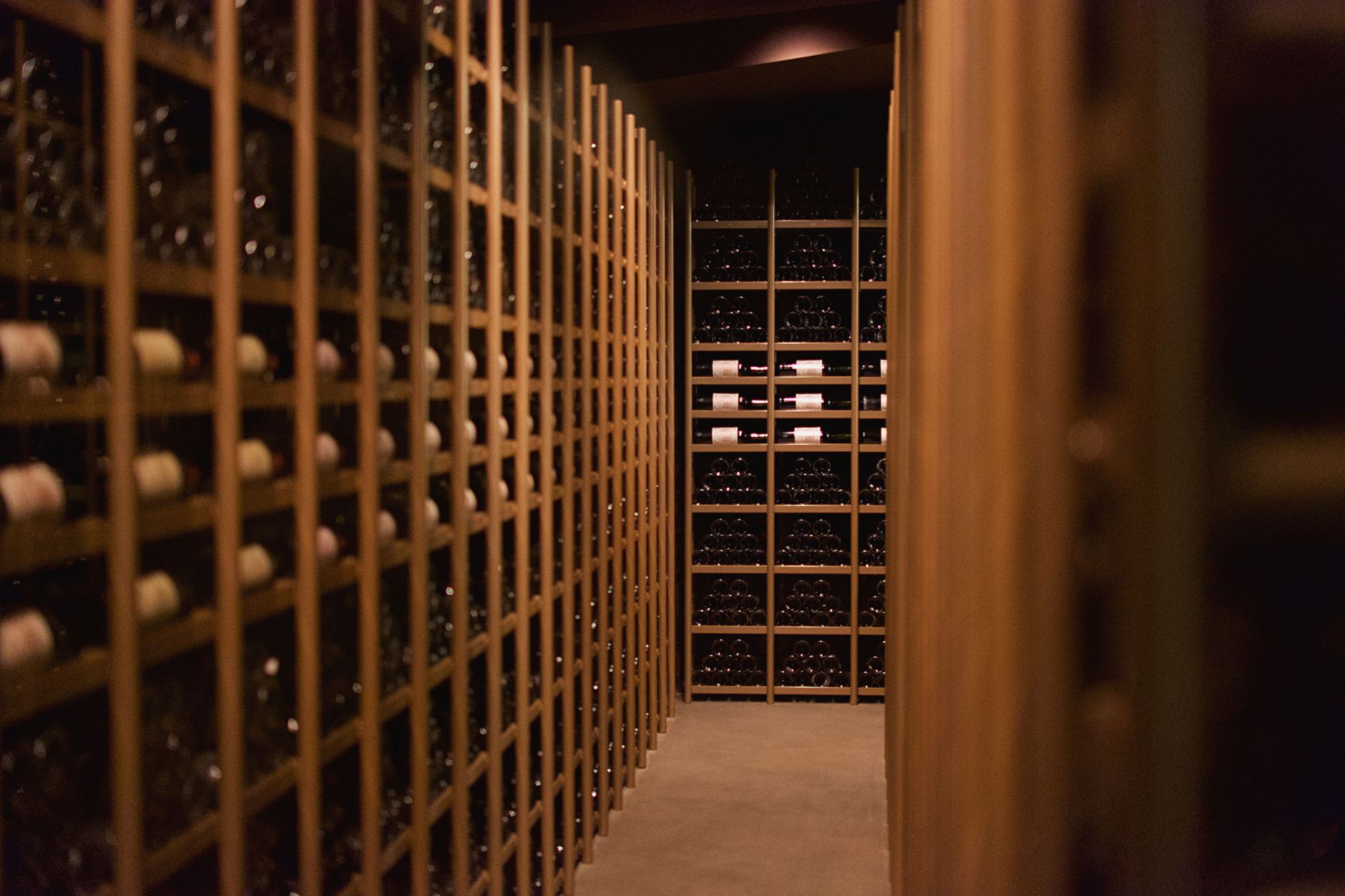Custom wine cellar with wooden racks and warm ambient lighting